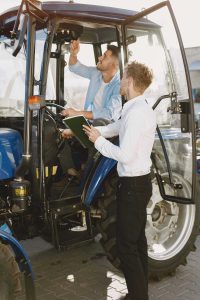 agronomist-choosing-new-planter-man-outdoor-ground-shop-agricultural-machinery