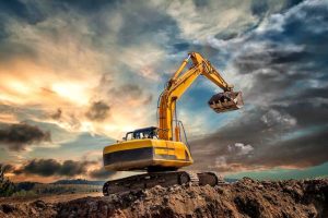 earth-mover-construction-site-against-sky-sunset