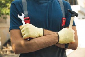 man-overalls-holds-construction-tools-outdoor
